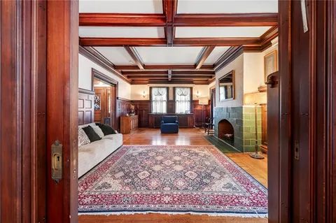 a living room with furniture rug and a fireplace