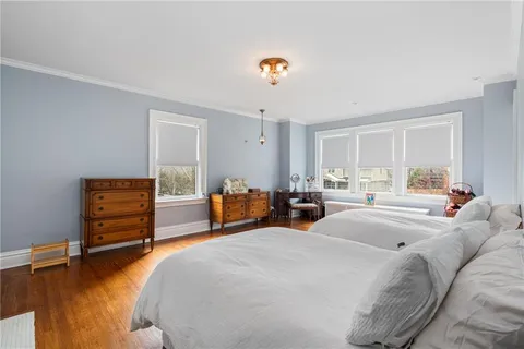 a bedroom with furniture and a wooden floor