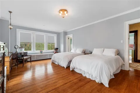a spacious bedroom with two beds and a large window