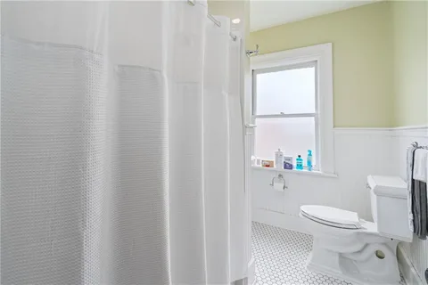 a white toilet sitting next to a white sink
