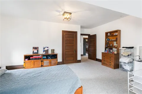 a bedroom with a bed and dresser