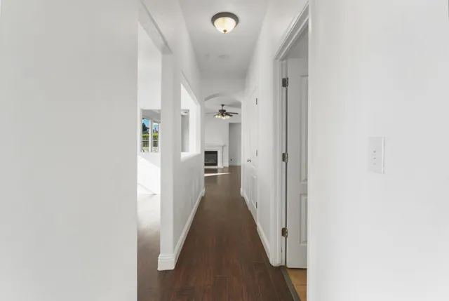 a view of a hallway with wooden floor