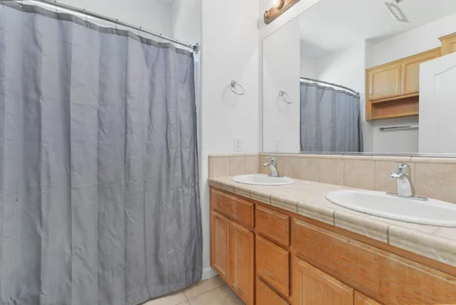 a bathroom with a double vanity sink and mirror