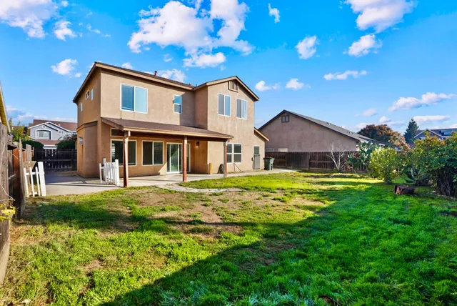 a front view of a house with yard and porch