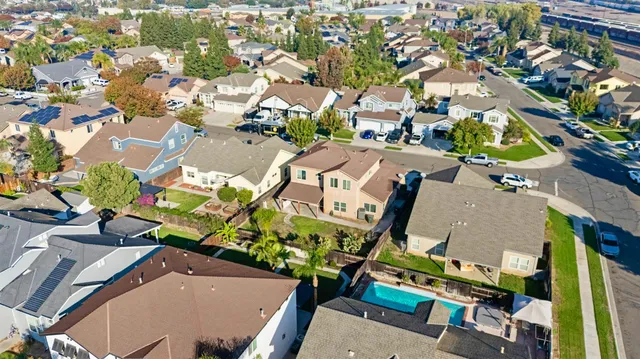 an aerial view of a houses with yard