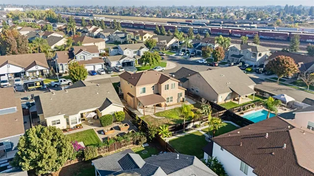 an aerial view of a house with a yard basket ball court and outdoor seating