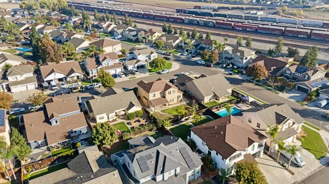 an aerial view of a swimming pool with outdoor seating