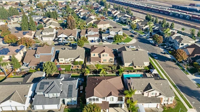 an aerial view of multiple houses with yard