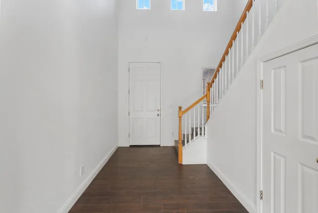 a view of an entryway with wooden floor