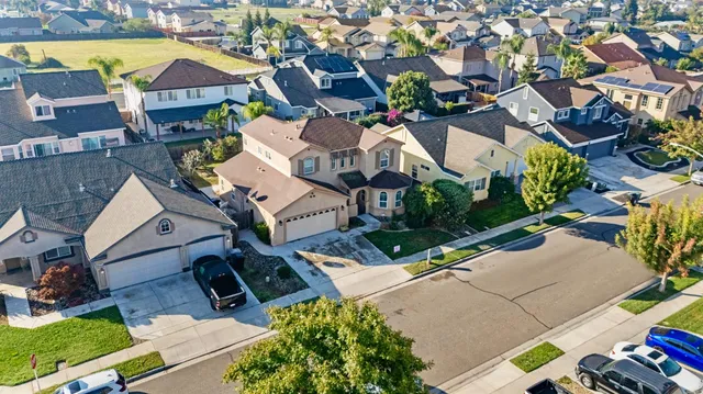 an aerial view of residential houses with outdoor space