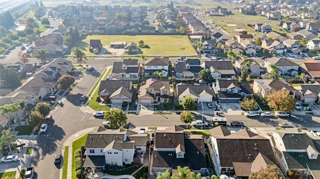 an aerial view of a swimming pool with outdoor seating