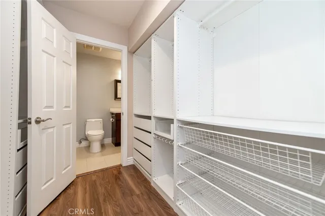 a bathroom with a granite countertop sink toilet a mirror and shower