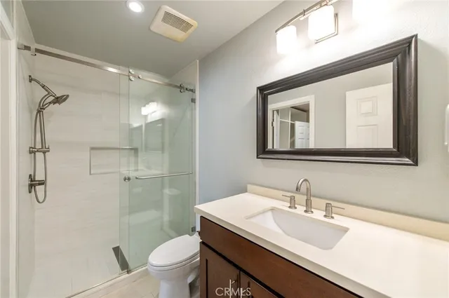 a bathroom with a sink vanity and a mirror