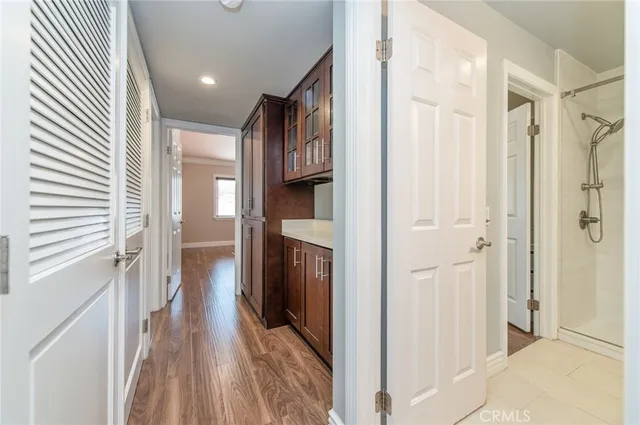 a view of a hallway with wooden floor and staircase