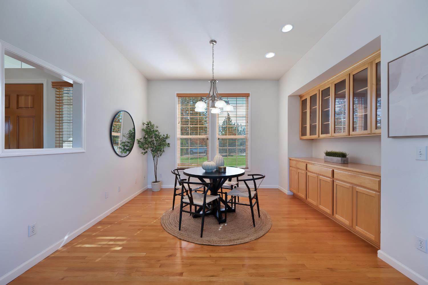 19740 Wedemeyer Place Applegate, CA 95703 - Photo 16 of 59 a dining room with wooden floor a chandelier a wooden table and chairs