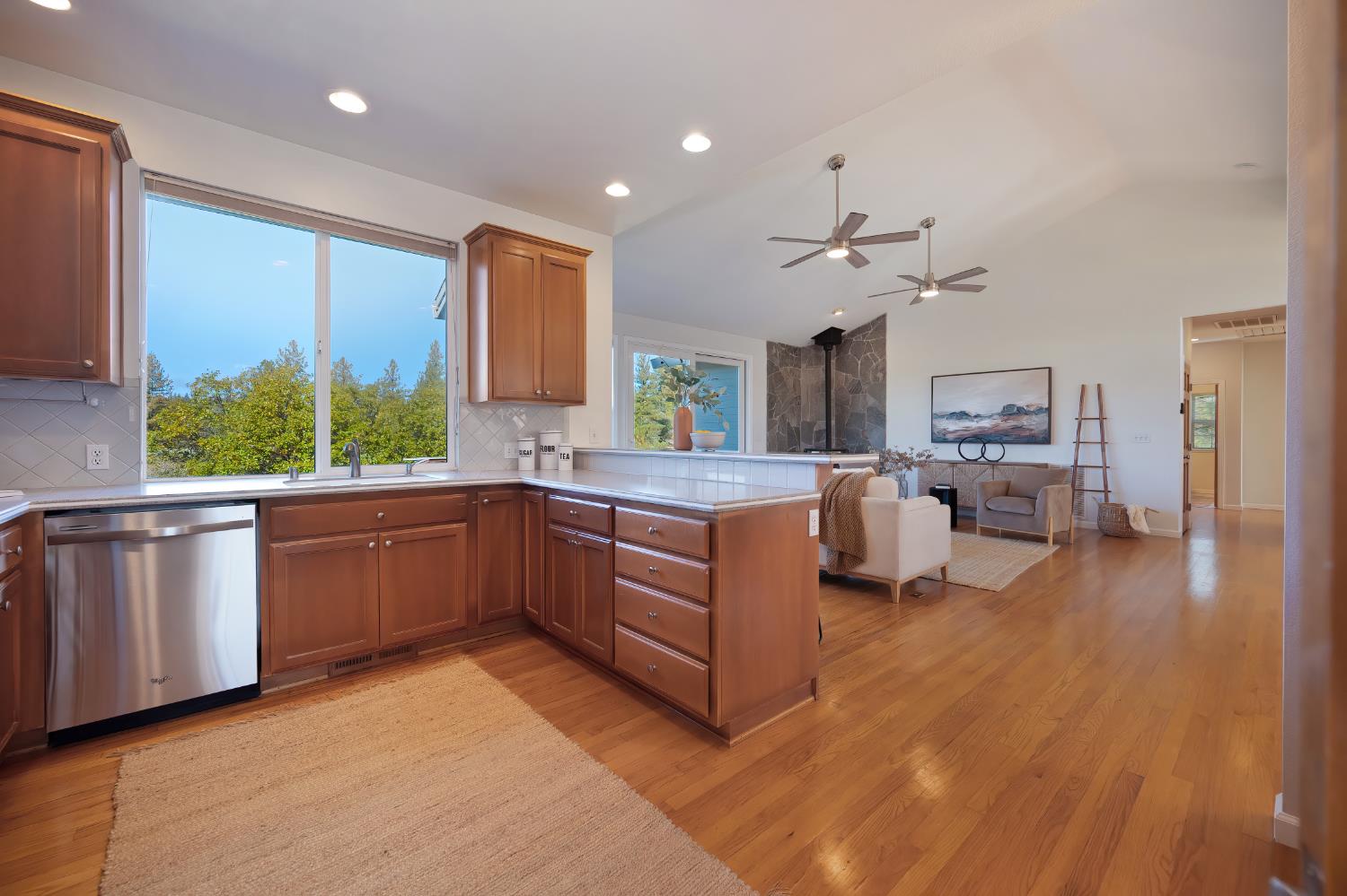 19740 Wedemeyer Place Applegate, CA 95703 - Photo 23 of 59 a kitchen with stainless steel appliances kitchen island granite countertop a stove a sink and a refrigerator