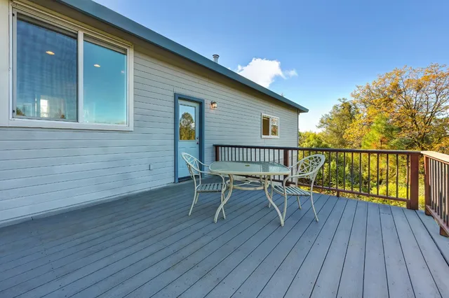 a balcony with wooden floor and fence