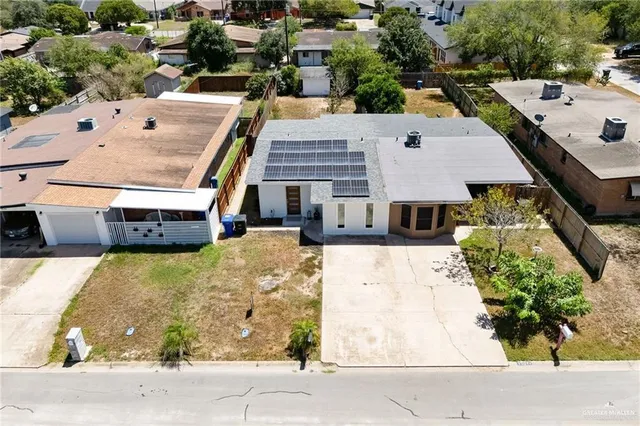 an aerial view of a house with a yard