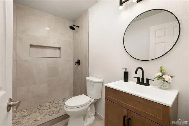 a bathroom with a sink a toilet and a mirror