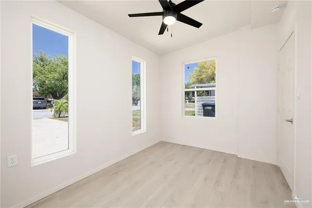 a view of a livingroom with a window and a ceiling fan