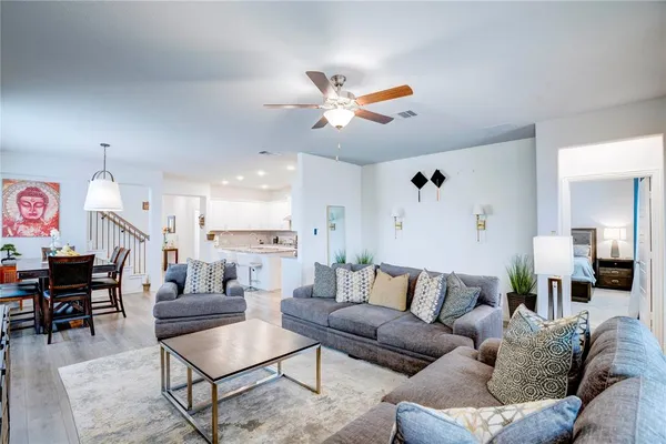 a living room with furniture and kitchen view