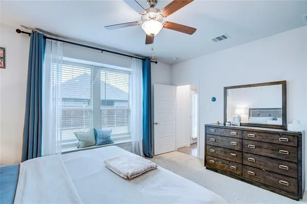 a bedroom with a large bed and a chandelier