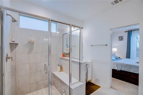 a bathroom with a double vanity sink and shower