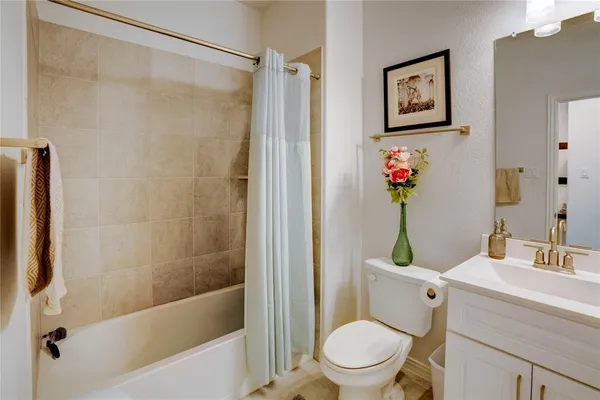 a bathroom with a shower a toilet and a sink