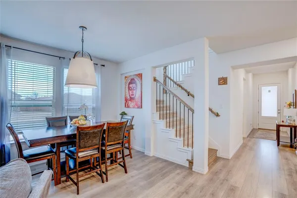 a dining room with furniture window and wooden floor
