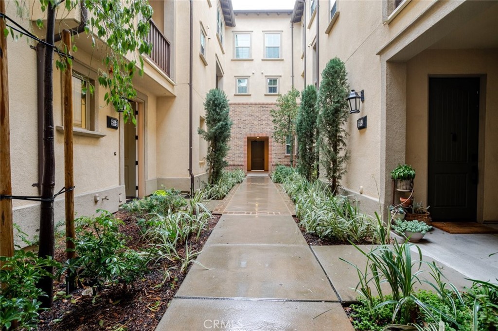 a entryway of a house with flower pots