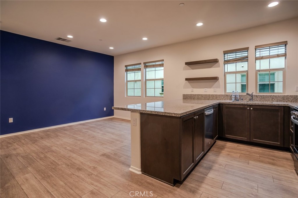 863 Iris Way, Unit B Azusa, CA 91702 - Photo 11 of 29 a kitchen with stainless steel appliances granite countertop a stove a sink and a refrigerator