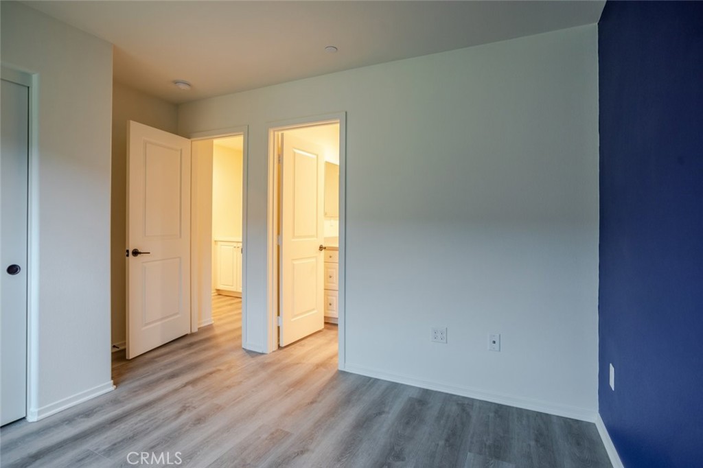 863 Iris Way, Unit B Azusa, CA 91702 - Photo 20 of 29 a view of an empty room with wooden floor and a window