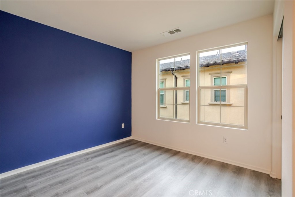 863 Iris Way, Unit B Azusa, CA 91702 - Photo 21 of 29 an empty room with wooden floor and windows