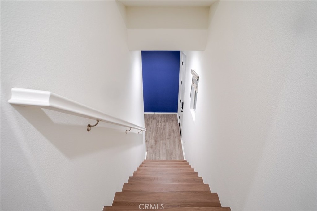 863 Iris Way, Unit B Azusa, CA 91702 - Photo 5 of 29 a view of a hallway with wooden floor and staircase