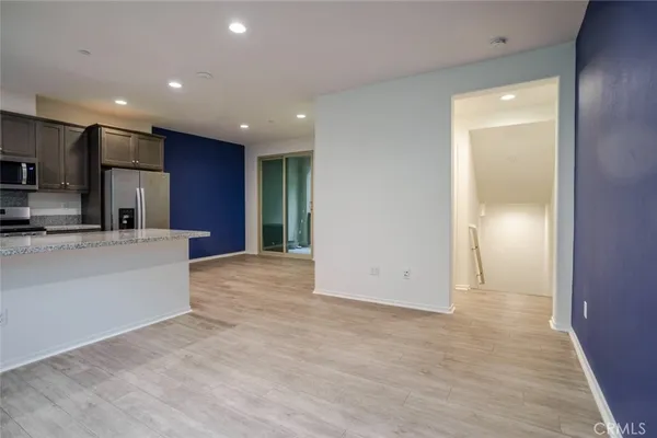a view of kitchen with stainless steel appliances refrigerator sink and cabinets
