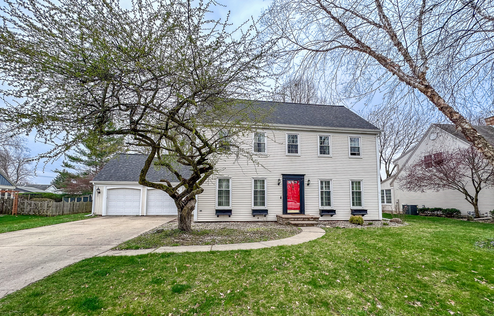 720 Periwinkle Turn Bourbonnais, IL 60914 - Photo 2 of 42 a view of a white house with a big yard and large tree