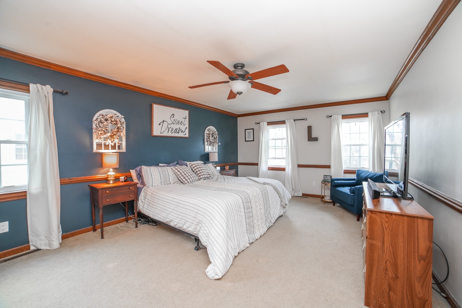 720 Periwinkle Turn Bourbonnais, IL 60914 - Photo 25 of 42 a spacious bedroom with a bed and a chandelier