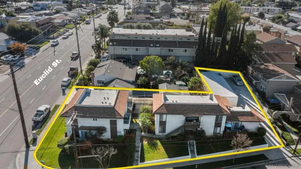 an aerial view of houses with swimming pool