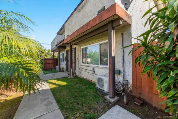 a view of a house with a small yard and plants