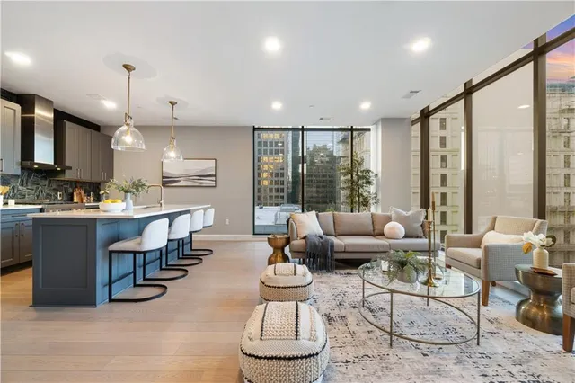 a living room with furniture a lamp and a large window