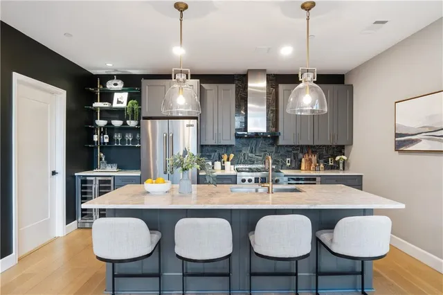 a kitchen with a stove a sink and a refrigerator