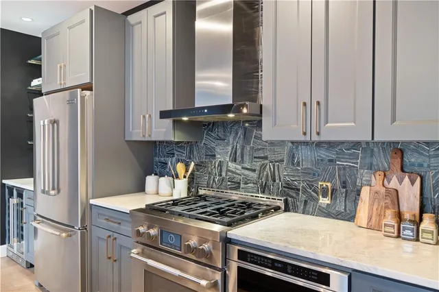 a kitchen with stainless steel appliances granite countertop a sink stove and refrigerator