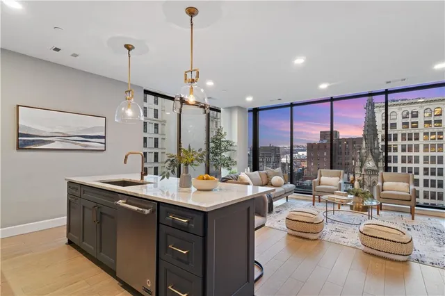 a bedroom with a large bed and a chandelier