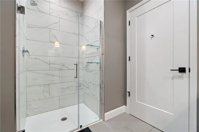 a view of a hallway with wooden floor and closet