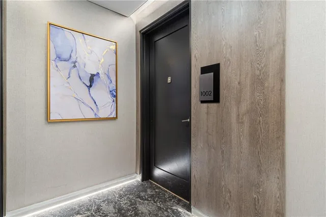 a view of a hallway with wooden floor and cabinet