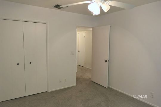 1122 North Inyo Street Ridgecrest, CA 93555 - Photo 21 of 34 a view of an empty room with a chandelier fan