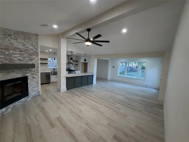 wooden floor in an empty room with a fireplace