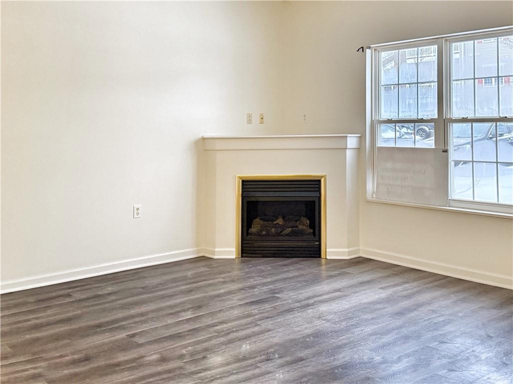 715 Stockton Ridge Cranberry Township, PA 16066 - Photo 6 of 27 an empty room with wooden floor fireplace and windows