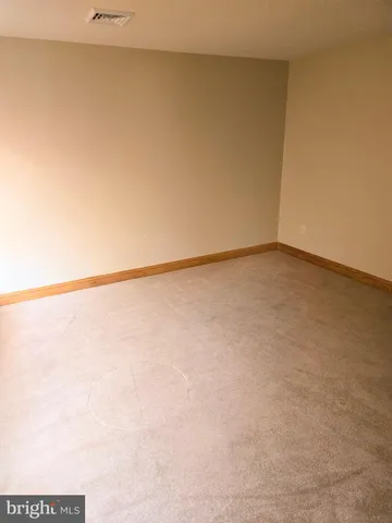 a view of a patio with a table and chairs under an umbrella