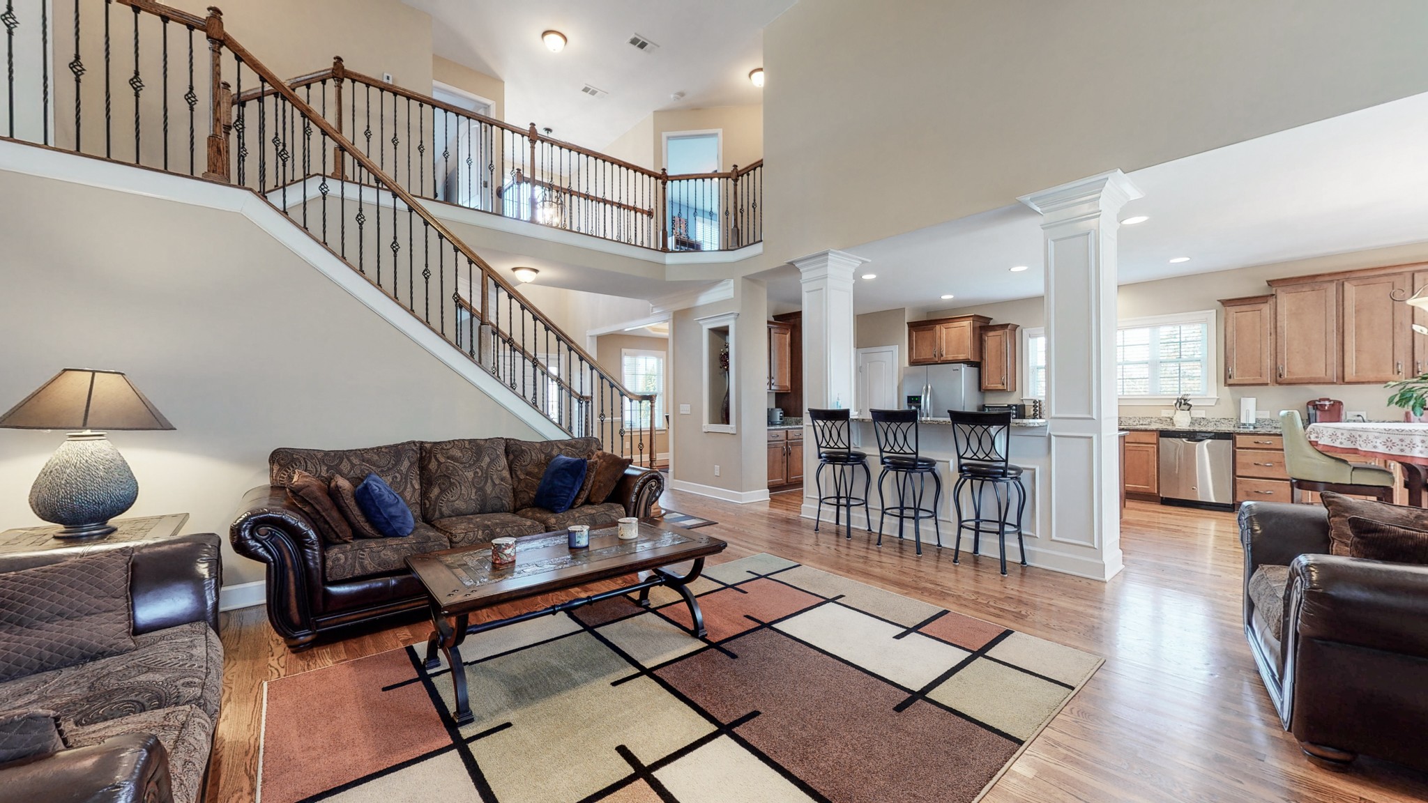 6137 Stags Leap Way Franklin, TN 37064 - Photo 12 of 27 a living room with furniture and a dining table with wooden floor